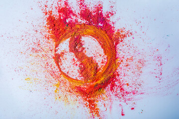 Multicolored holi powder in the form of a circle on a white background.