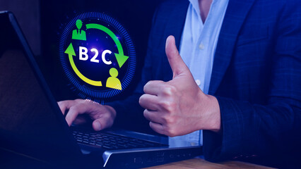 B2C, Business to customer marketing strategy concept. Businessman use laptop with virtual B2C icon...