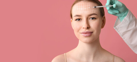 Beautiful young woman receiving filler injection in forehead on pink background with space for text