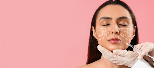 Young woman receiving filler injection in face against beige background