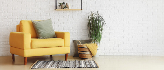 Interior of living room with stylish yellow armchair