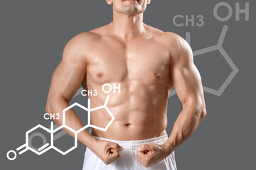 Muscular male bodybuilder showing muscles on grey background