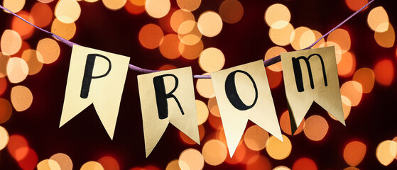 Flags with word PROM hanging against blurred lights
