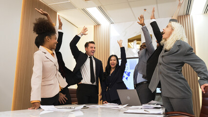 Diverse group of office worker and employee raise their hands up with happy and excited celebration...