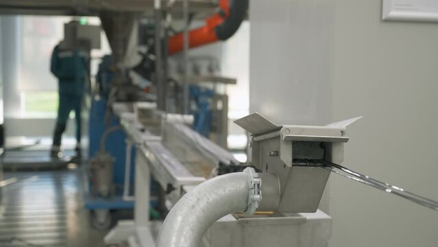 Automated extruder equipment deals with plastic compounding process. Plastic compounding extruder operating at the production plant. Plastic compounding extruder processing the raw material.