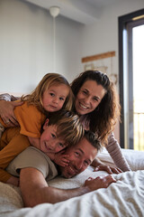 Happy family hugging in the bedroom, Having Fun Together