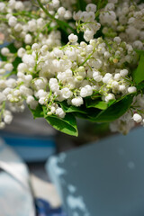 Delicate lily of the valley on a blue background.