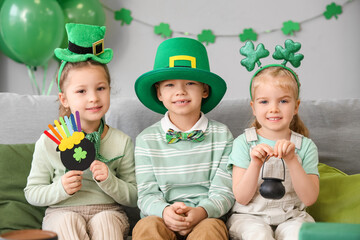 Cute kids celebrating St. Patrick's Day with festive green outfits at home party