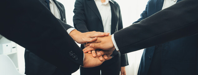 Office worker team stacking hand together symbolize successful group of business partnership and...