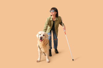 Blind woman with guide dog on beige background