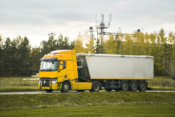 Fototapeta na wymiar Hauler Truck on Highway Delivering Construction Supplies in a Dump Trailer