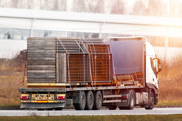 Truck delivering materials and machinery to the construction site.