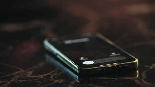A cell phone ringing on call aslaying on a table