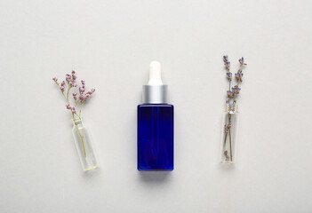 Bottle of lavender essential oil on white background