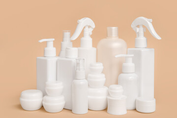 Composition with jars and bottles of cosmetic products on beige background