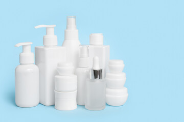 Different cosmetic products on blue  background