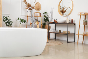 Interior of bathroom with bathtub, sink and accessories