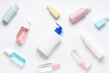 Many different bottles of sanitizers on white background