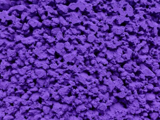 Violet painted stone wall or fence texture background. Beautiful ultra-violet gravel wall pattern. Textured house ground floor. Home colorful violet wall exterior design. Abstract new celebration fond