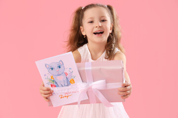 Cute little girl with gift box and card for Mother's Day on pink background
