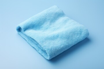 Fluffy blue towel on a light background - obrazy, fototapety, plakaty