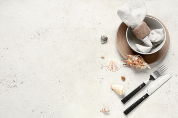 Beautiful table setting with seashells on white grunge background © Pixel-Shot