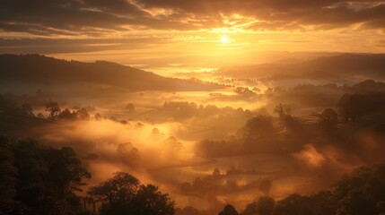 Fototapeta na wymiar The sun rises over a mist-covered valley, casting a warm glow on the tranquil landscape below, a serene moment of awakening and possibility.