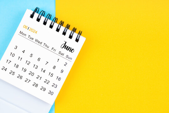 June 2024, Monthly desk calendar for 2024 year on yellow and blue background.