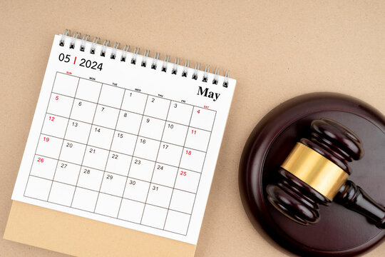 Desk calendar for May 2024 and judge's gavel.