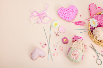 Handmade spring decor concept. Creative crocheting, house figurine, traditional flowers and hearts