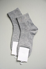 Mens new socks on a gray background, close-up. Cotton socks with blank label - 796279748