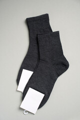 Mens new socks on a gray background, close-up. Cotton socks with blank label - 796279783