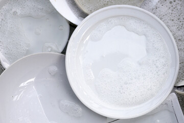 Fototapeta na wymiar Dish washing, Dirty dishes soaking in kitchen sink.
