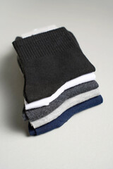 Mens new socks on a gray background, close-up. Cotton socks with blank label