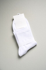 Mens new socks on a gray background, close-up. Cotton socks with blank label