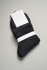 Mens new socks on a gray background, close-up. Cotton socks with blank label - 796280182