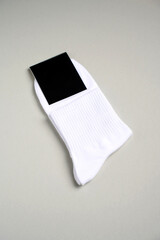 Mens new socks on a gray background, close-up. Cotton socks with blank label
