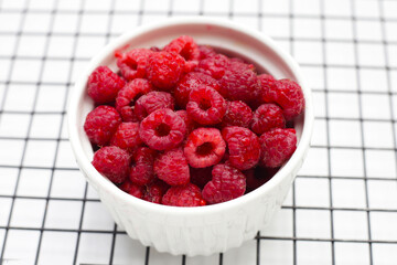Fresh raspberry on white background.