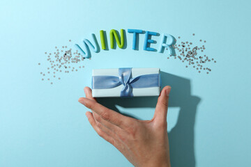 The word "winter" is made of colored plasticine on a blue background.