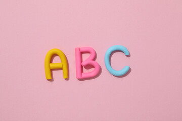 The alphabet is laid out from colored plasticine.