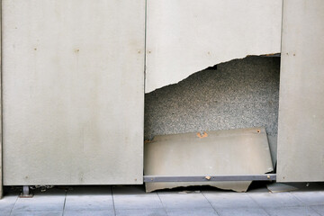 The plywood covering the wall was damaged and had holes in it.