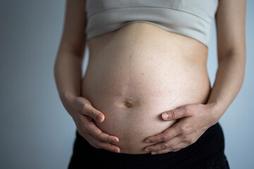 Close up of pregnant woman's belly