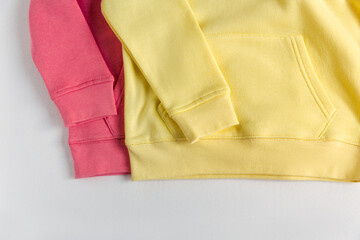 Yellow and red  hoodies mockup on the white background. Crop view. Fashion outfit, casual style. Basic stylish clothing.