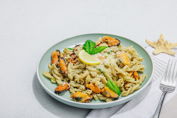 Plant based pasta with mussels, pesto and parmesan cheese. Ready to eat healthy food, served portion