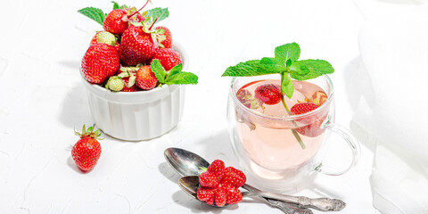 Strawberry tea concept. Good morning concept. Teapot, ripe fruits, healthy beverage