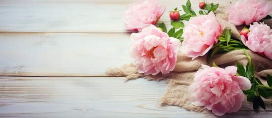Pink flowers on rustic cloth and wooden table