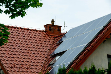 Historic farm house with modern solar panels on roof and wall