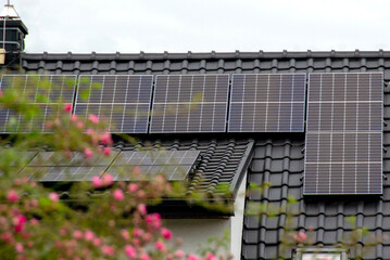 Historic farm house with modern solar panels on roof and wall