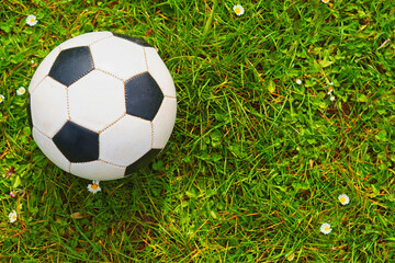 A soccer ball over a green grass field - Powered by Adobe