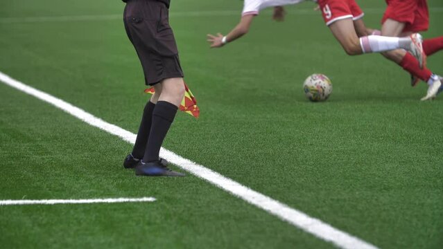 Side Judge, Concept of Refereeing in Football. Professional Soccer Players Attacks, Fall Down, Foul. Athlete In Pain Lying on the Grass 